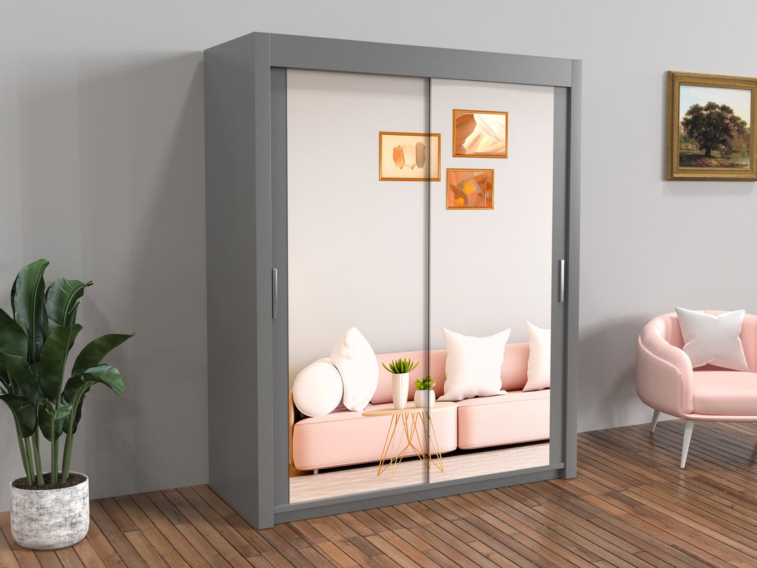 Gray sliding wardrobe with mirror doors in a room with pink sofa and decor.